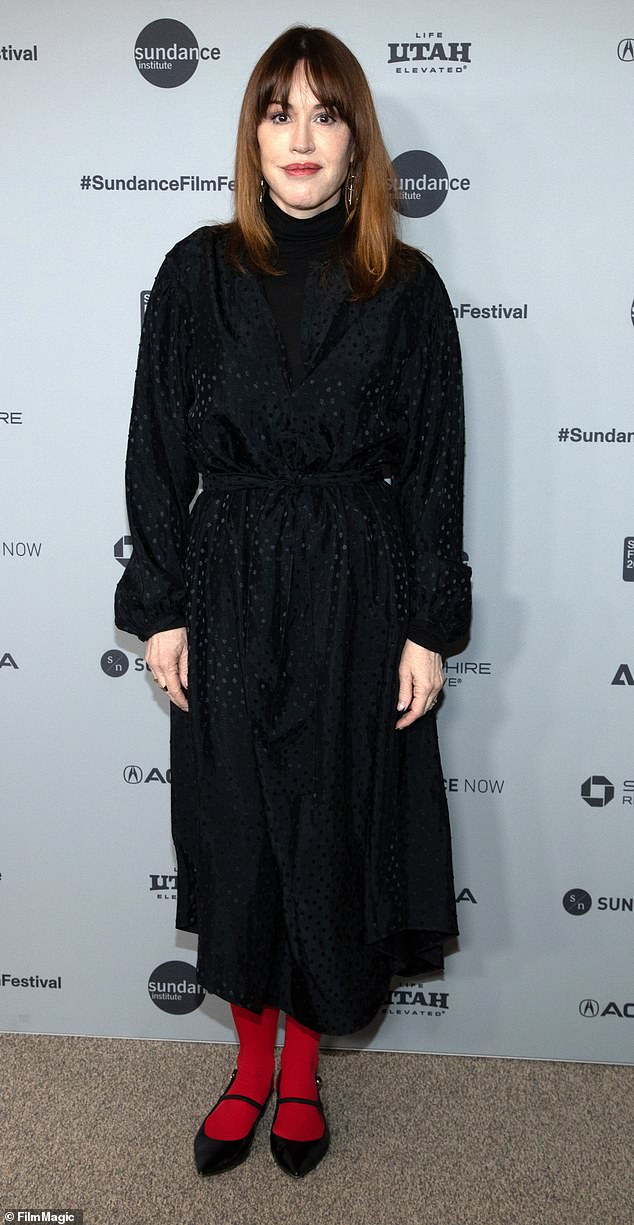 Red-y for Sundance, it seems. Actress Molly Ringwald chose a bizarre pop of color to complete her outfit on Monday as she attended the Run Amok premiere. Ringwald paired her silk, long-sleeve polka dot dress with a pair of bright red tights and ill-fitting strappy black ballet flats. She tied it together with a pink-red lip and minimal jewelry