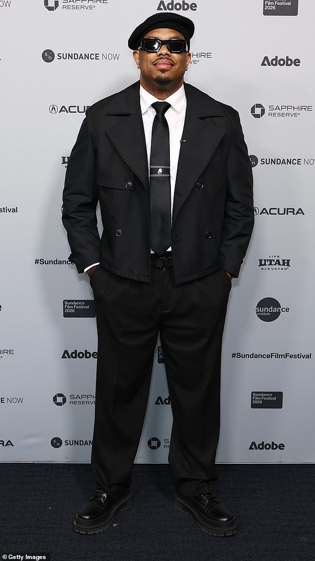 Comedian Lou Young looked super chic as he attended the Episodic Fiction Pilot Showcase on Tuesday at Sundance. He wore a cropped, black peacoat-style jacket, sharp tie and black dress pants. He completed his look with a black hat, thick black square-lensed sunglasses, and patent leather black dress shoes