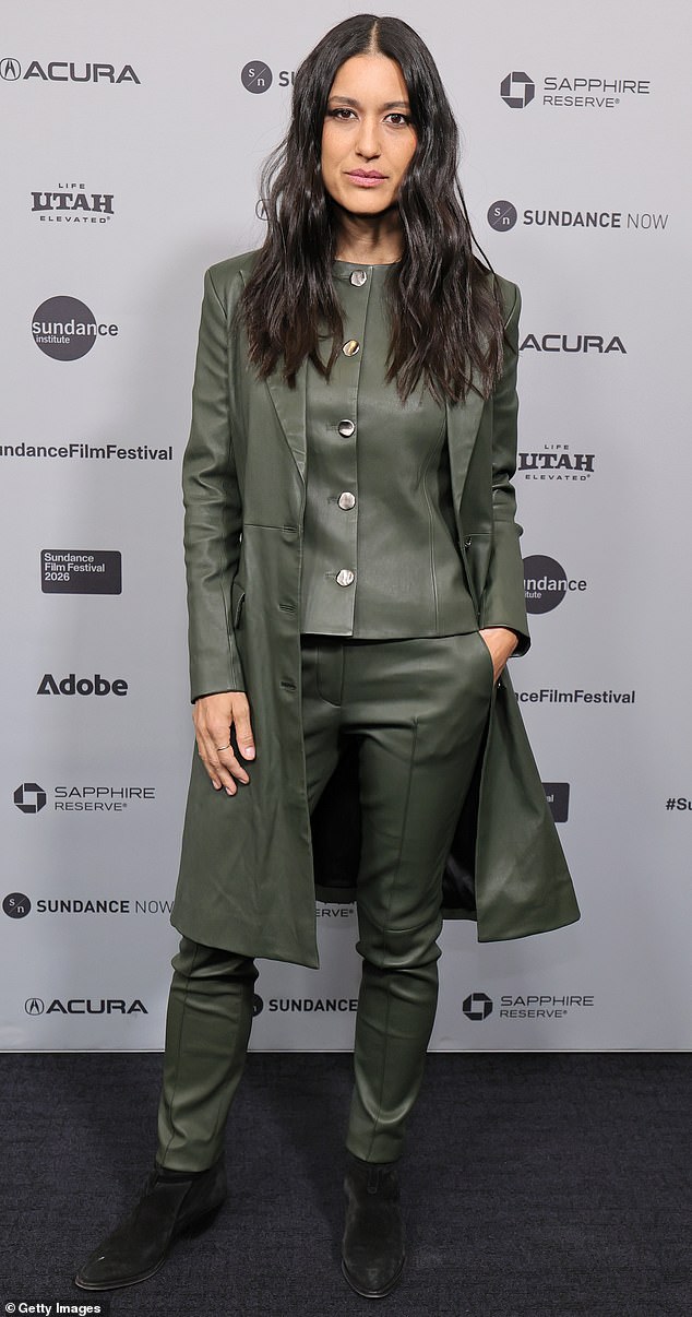 Magnificent monochrome! Actress Julia Jones rocked a dark, forest-green monochromatic leather look. Her suit included skinny pants, a tank top with silver buttons going up the front, and a long jacket. She completed the fun look with a pair of black boots and minimal jewelry