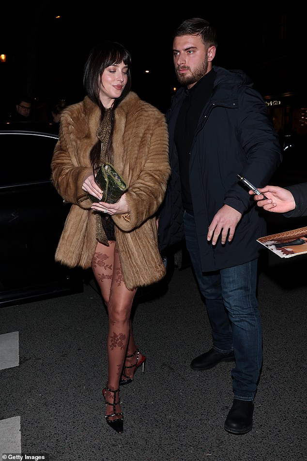 Also spotted at the Valentino party was Dakota Johnson, who was flanked by a bodyguard as she got out of a taxi