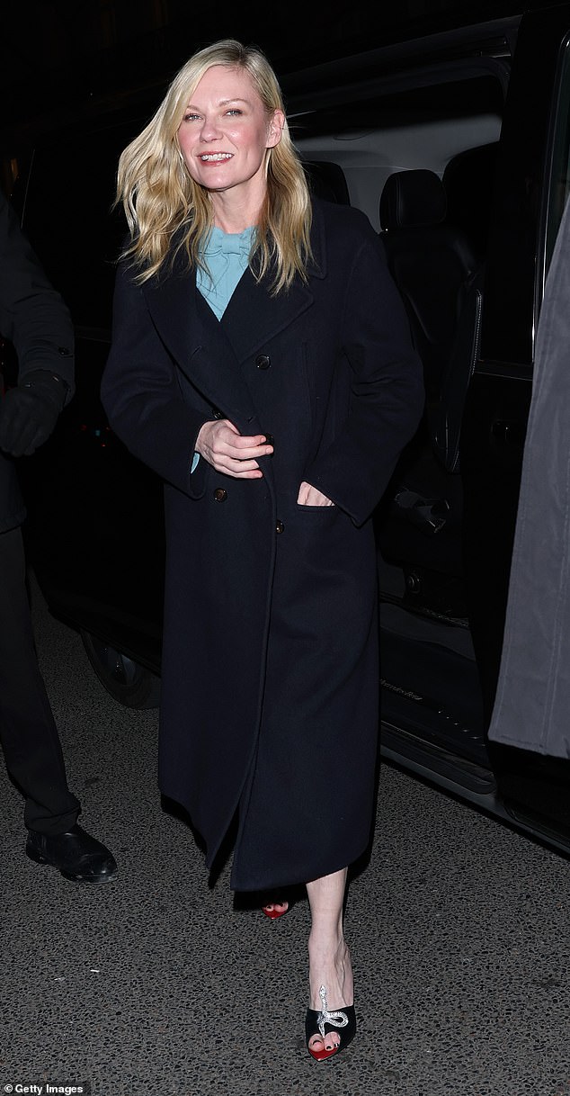 Meanwhile Spider Man star Kirsten Dunst kept her look understated as she wore a navy longline coat over a blue bow dress