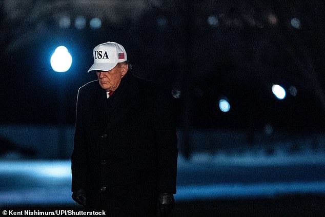 US President Donald Trump walks on the South Lawn of the White House after arriving on Marine One in Washington, DC on Tuesday, January 27