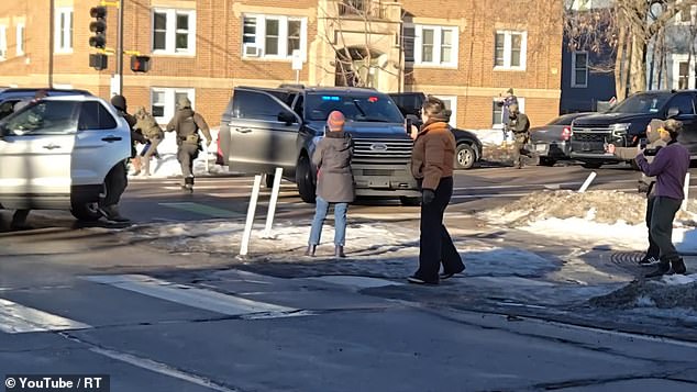 After hurling several expletives at the agents, they converge on him after he kicks the tail light of a federal SUV