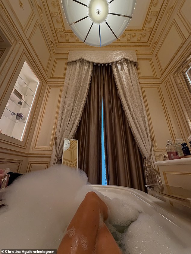 Aguilera gave another glimpse inside her lavish Parisian lodgings as she snapped a selfie while taking a relaxing bath