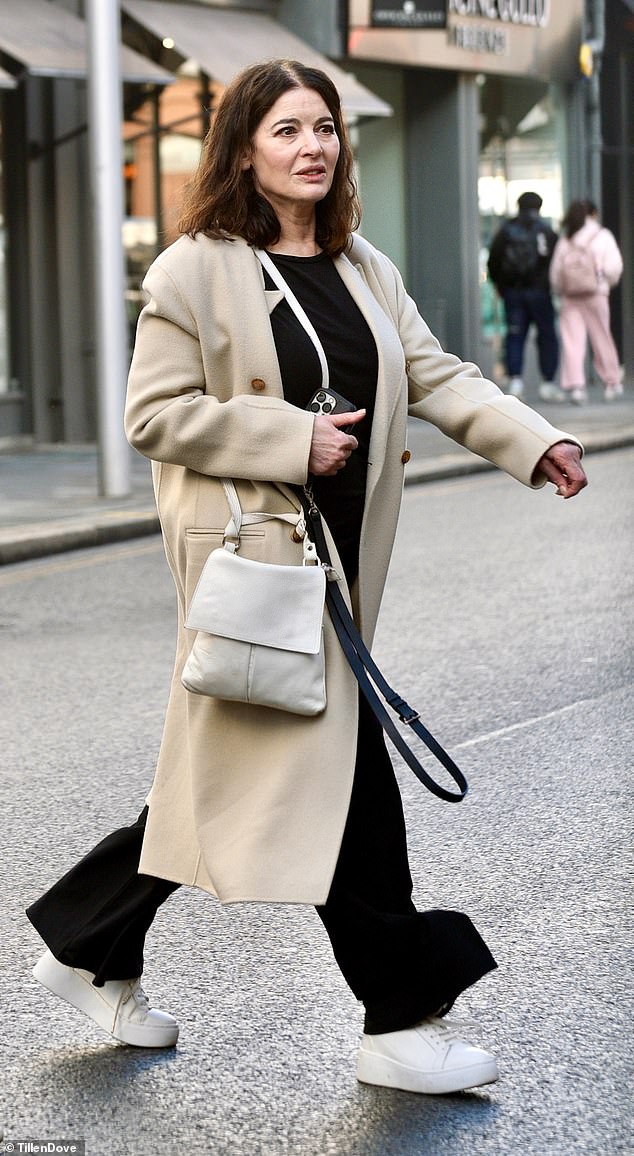 Nigella, who is set to join Paul Hollywood, 59, in the famous tent later this year, cut a stylish figure in a beige long coat which she layered over a black T-shirt and matching trousers