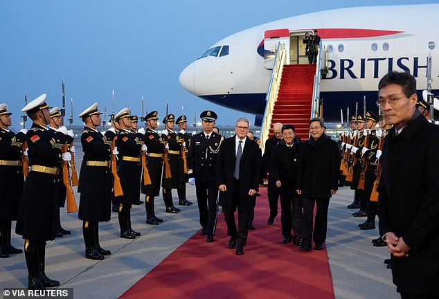 The PM touches down and is flanked by the British Ambassador to China Peter Wilson