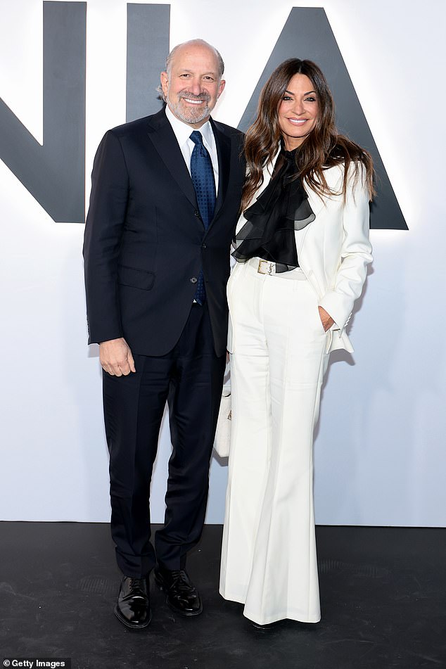 Coordinating couple! United States Secretary of Commerce Howard Lutnick and his wife, Allison, looked great as they both stunned in pantsuits. Allison pulled off a winter-white suit with flared bottoms and a dramatic, ruffled black blouse underneath. Lutnick, for his part, wore a sharp, navy blue suit with a blue satin tie