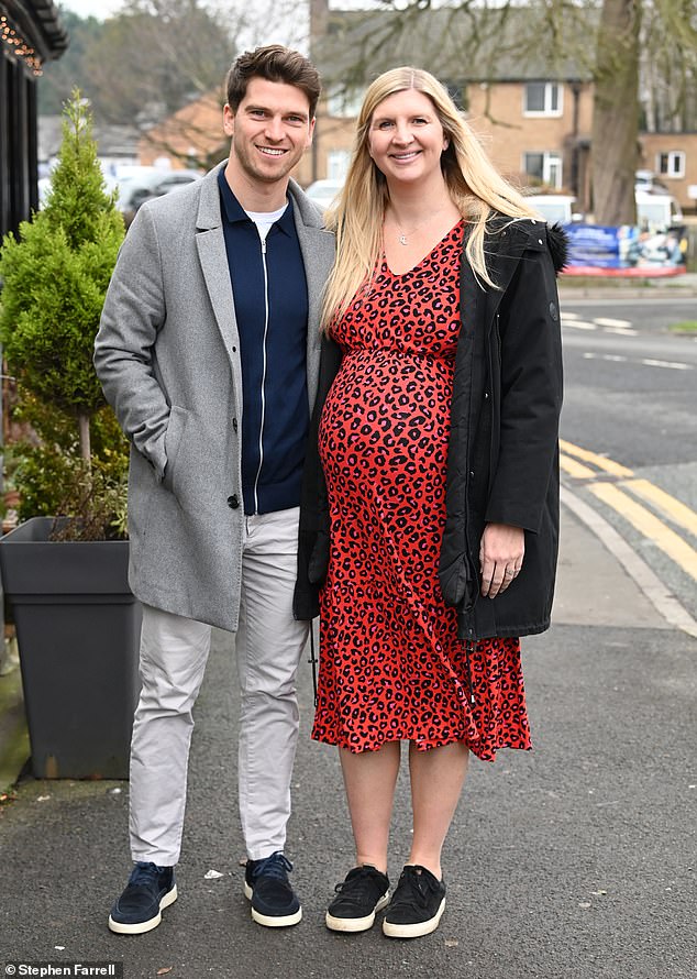 Rebecca, who was joined by Andy at the event, showed off her growing baby bump in a red and pink leopard print midi-dress