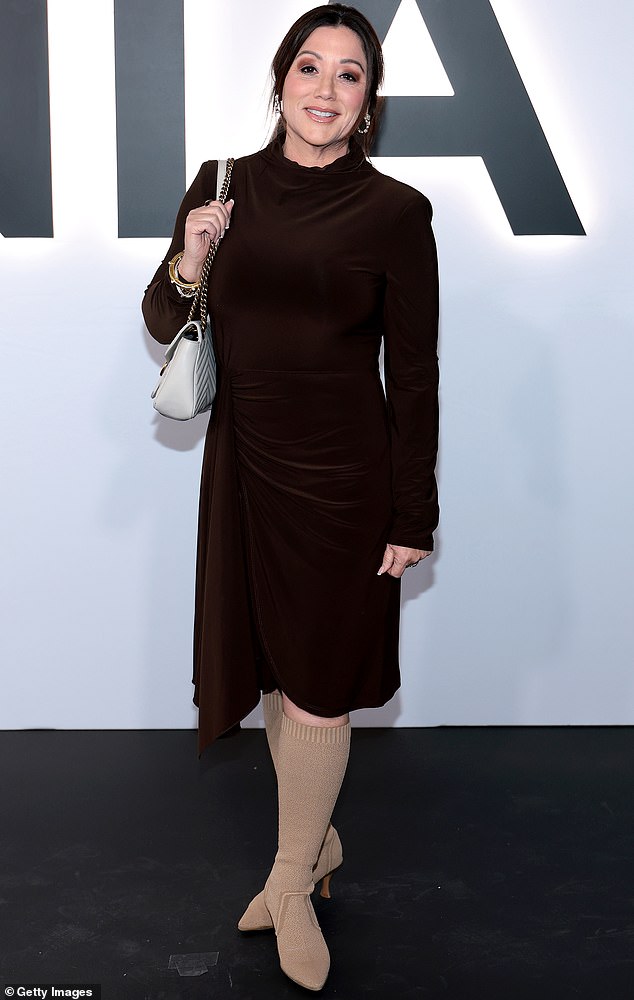 These boots should not be made for walking! United States Secretary of Labor Lori Chavez-DeRemer sported a pair of sock-style, knee high boots on the red carpet at the Melania premiere. The boots were a tan color, which she matched with her neutral-colored handbag. She paired it all with a burgundy-colored, velvet turtleneck dress that featured draping along the waist