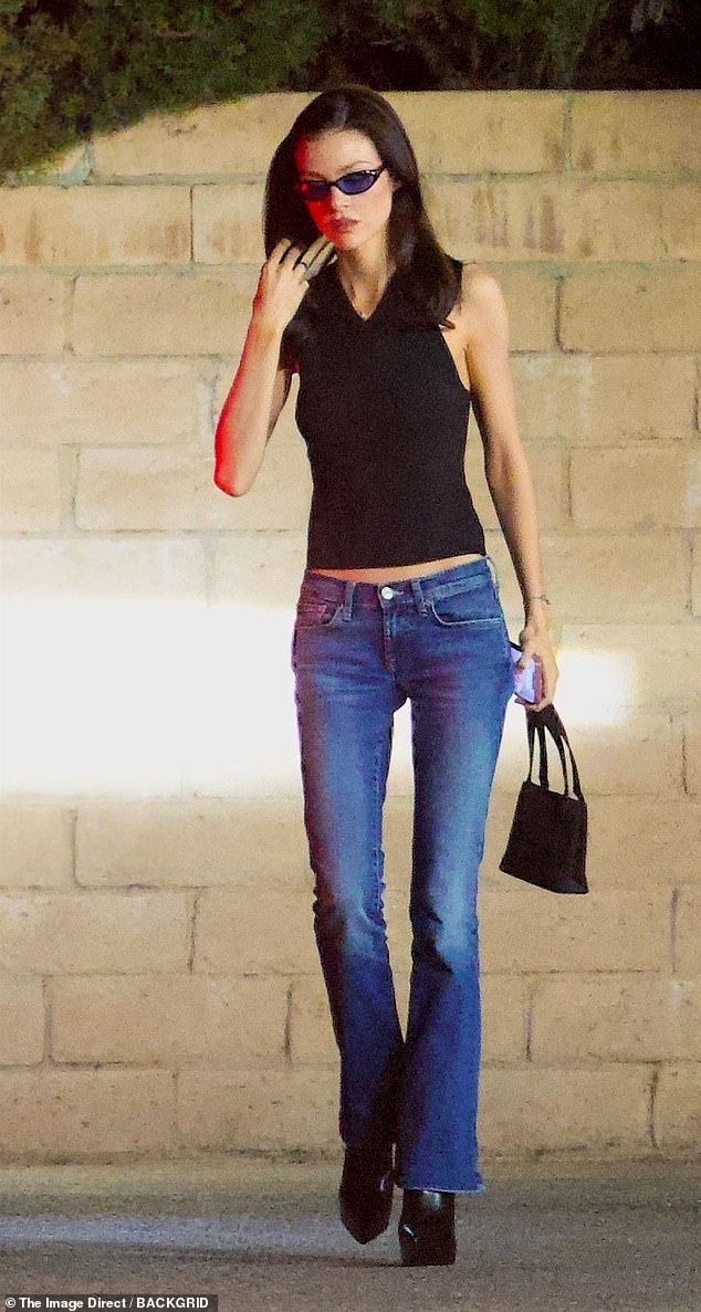 Nicola looked stylish in a black halterneck top, indigo jeans and heeled boots