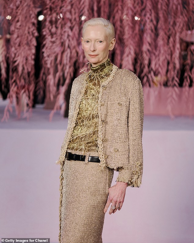 Chanel global ambassador Tilda Swinton wears a golden tweed suit at the fashion house's Haute Couture Week Spring/Summer 2026 show in Paris