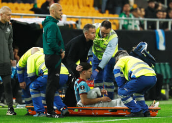 Emotional moment 'heartbroken' Robin van Persie consoles son Shaqueel, 19, as he is stretchered off with horror injury