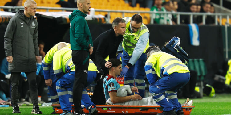 Emotional moment 'heartbroken' Robin van Persie consoles son Shaqueel, 19, as he is stretchered off with horror injury