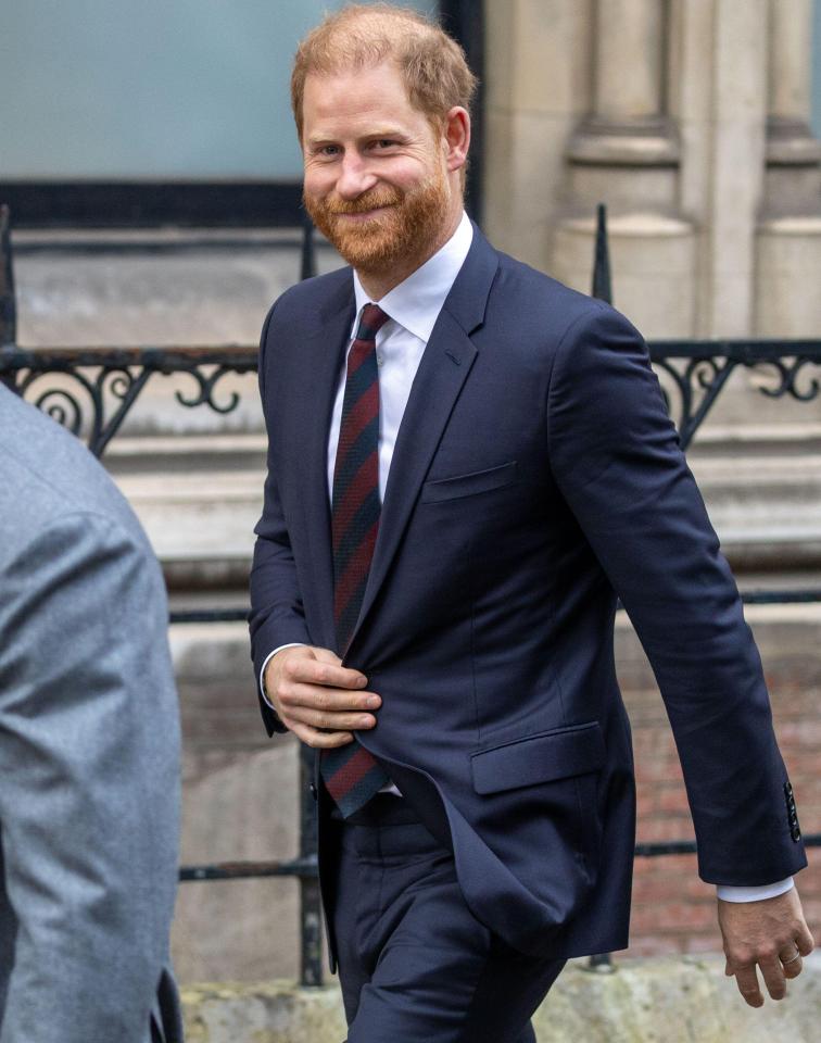 Prince Harry smiling while leaving the Royal Courts of Justice.