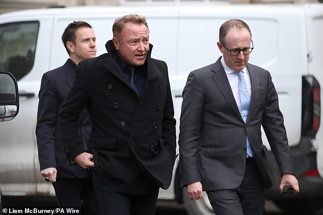 Michael Flatley (centre) leaving Belfast High Court, after a legal order blocking him from engaging with the Lord of the Dance production has been overturned