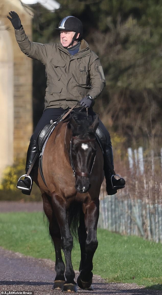 Andrew waves as he is seen horseriding in Windsor on Saturday morning