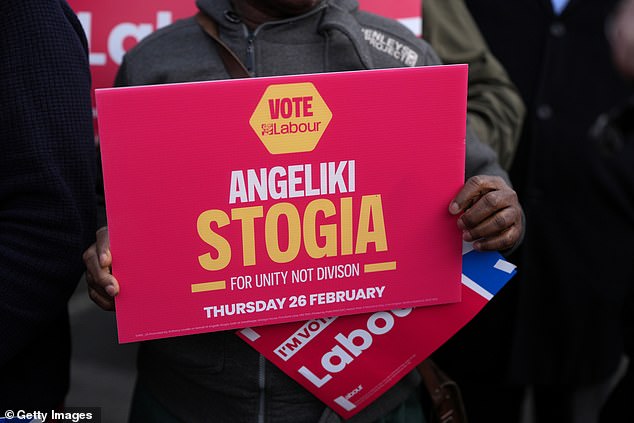 Labour supporters hold placards in support of Angeliki Stogia as she is announced as the Labour Party candidate for the Gorton and Denton by-election