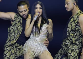 US popstar, 58, defies age as she performs on stage in tiny sparkling minidress and puts endless pins on display