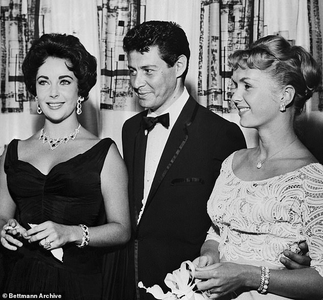 It was originally a gift to Taylor from her third husband Mike Todd, with the actress describing the necklace as 'Like the sun, lit up and made of red fire' (Taylor pictured wearing the necklace in 1958 with Eddie Fisher and Debbie Reynold)