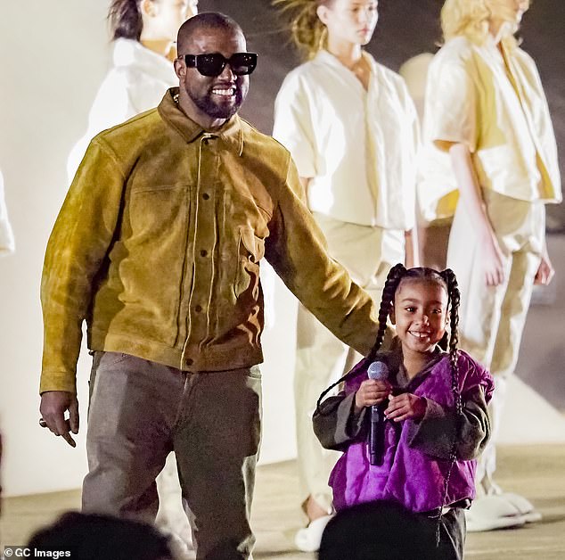 North wrote Piercing On My Hand with her father - and seemingly is a response to negative criticism to her piercings; West and North seen in 2020 in Paris