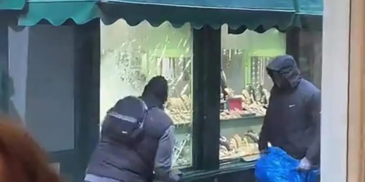 Shock moment hammer-wielding thugs break into London jewellery store in brazen robbery in front of terrified onlookers