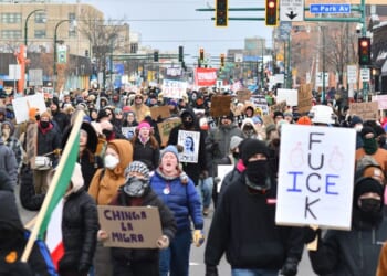 Protesters hold signs as they march from Powderhorn Park in Minneapolis against Immigration and Customs Enforcement and the fatal shooting of Renee Good by an ICE agent, calling on federal authorities to leave the city and demand accountability, in Minneapolis, Minnesota, on Jan. 10, 2026.