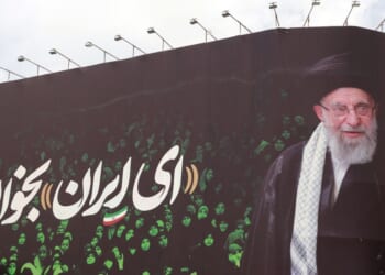This picture shows a billboard bearing the portrait of Iranian supreme leader Ayatollah Ali Khamenei and a quote reads in Persian "Sing Oh Iran" at the Enqelab Square in Tehran on July 9, 2025.