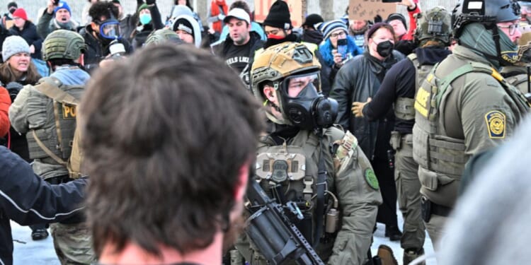Federal agents confront anti-ICE agitators outside the Bishop Henry Whipple Federal Building in Minneapolis on Jan. 8, 2026.