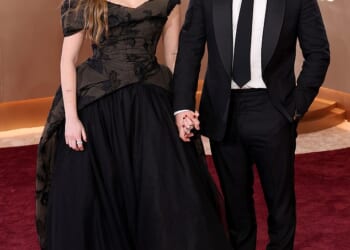 Aimee Lou Wood, 31, stunned in a black ballgown as she cosied up to her boyfriend Adam Long, 34, at the Golden Globes in LA on Sunday