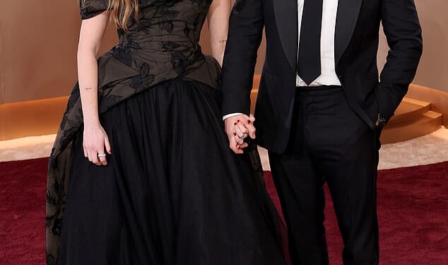 Aimee Lou Wood, 31, stunned in a black ballgown as she cosied up to her boyfriend Adam Long, 34, at the Golden Globes in LA on Sunday
