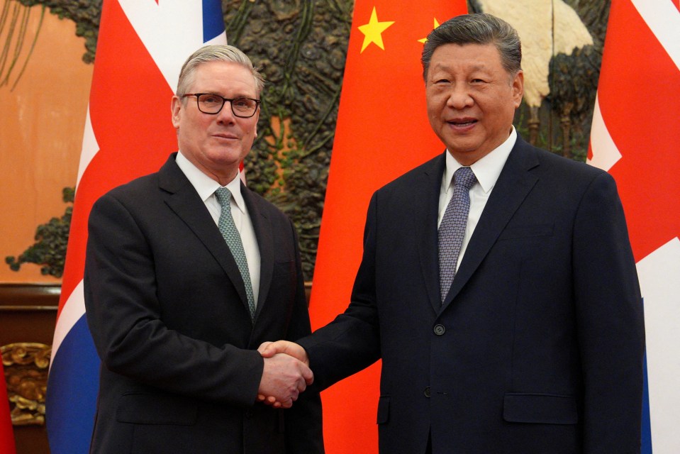 Britain's Prime Minister Keir Starmer and Chinese President Xi Jinping shake hands.