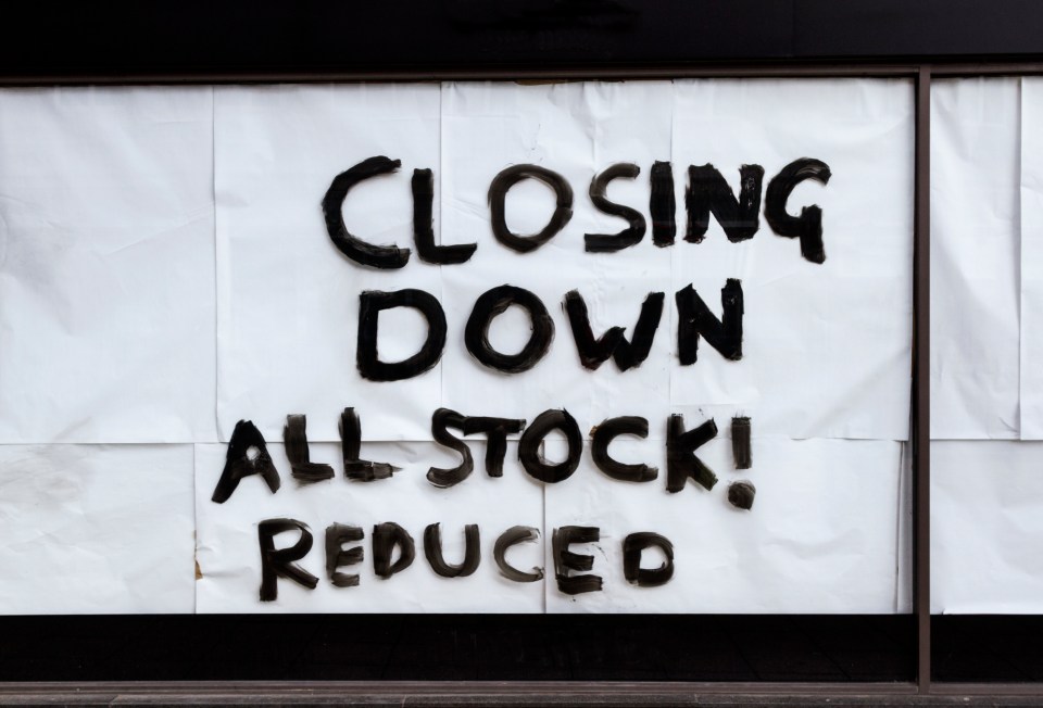 Closing Down All Stock! Reduced sign on a store window in Sheffield, UK.
