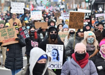 Protesters hold signs as they march from Powderhorn Park in Minneapolis against Immigration and Customs Enforcement and the fatal shooting of Renee Good by an ICE agent, calling on federal authorities to leave the city, in Minneapolis, Minnesota, on Jan. 10, 2026.