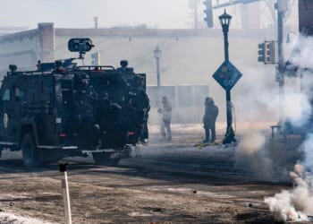 An armored vehicle arrives with Minneapolis police officers in Minneapolis, Minnesota, amid anti-ICE riots on Jan. 24, 2026.