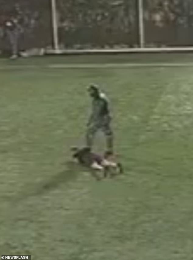 The masked hitmen were seen in the chilling footage kicking him as he lay helpless on the grass, before one of the killers shot him dead at point-blank range in front of the other players