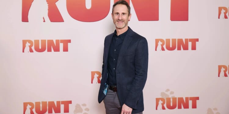 Author charged with child exploitation offences after police raided his home