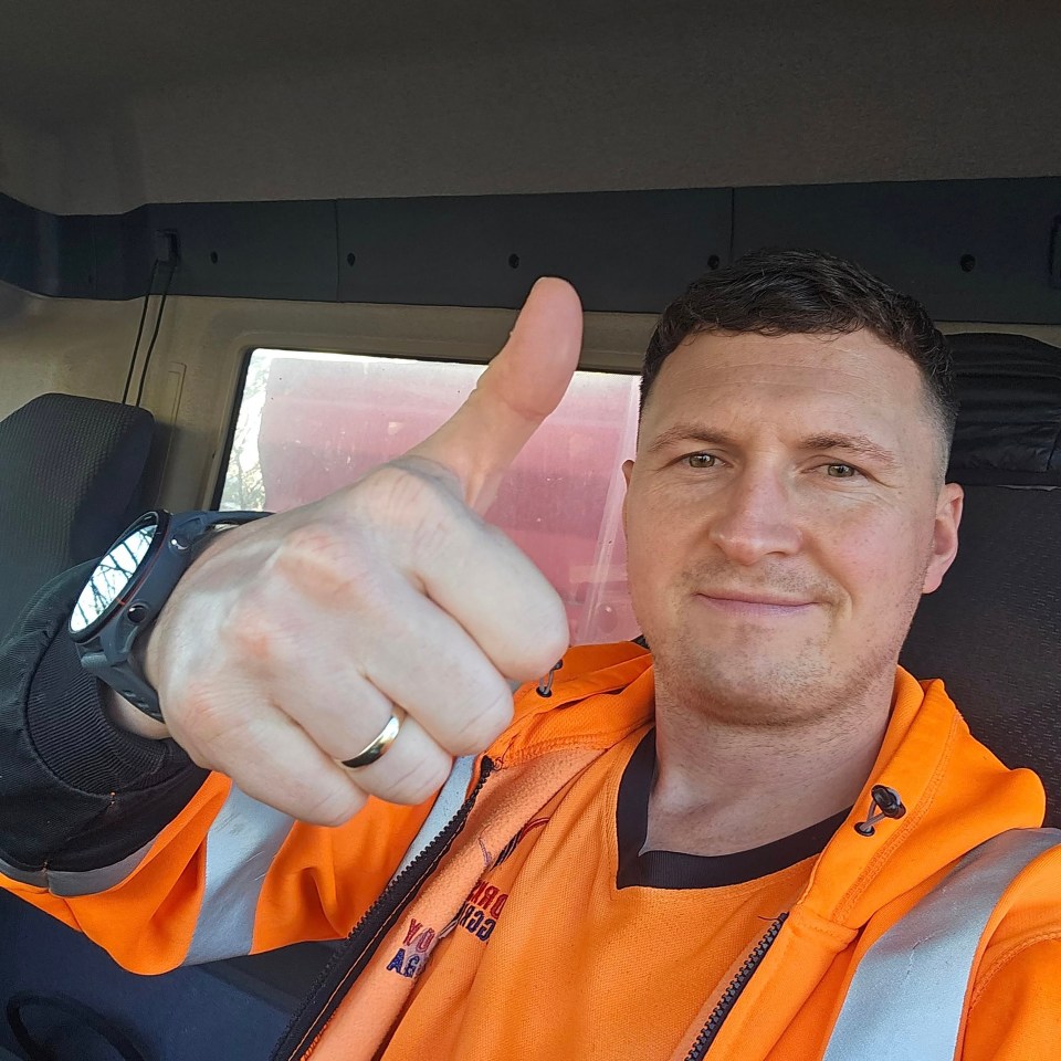 Levi Hague, an apprentice, wearing a bright orange high-visibility jacket and giving a thumbs-up.