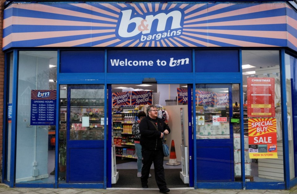 Shoppers walk by the B&M store in London.