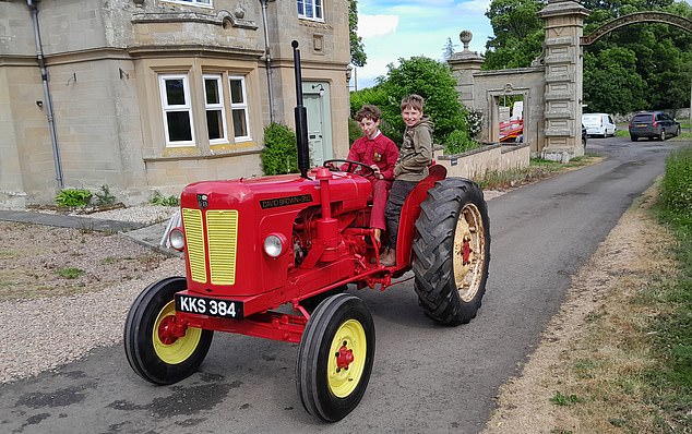 Alex and his younger brother Cameron take the tractor for a spin