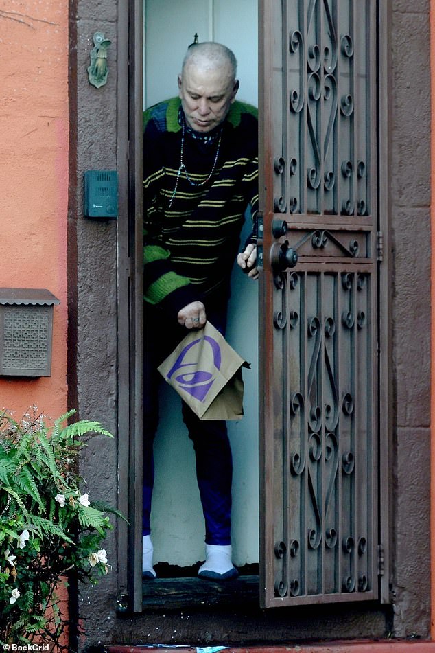 A bald Mickey Rourke looked unrecognizable as he emerged from the LA home he is potentially facing eviction from after allegedly failing to pay nearly $60,000 in rent