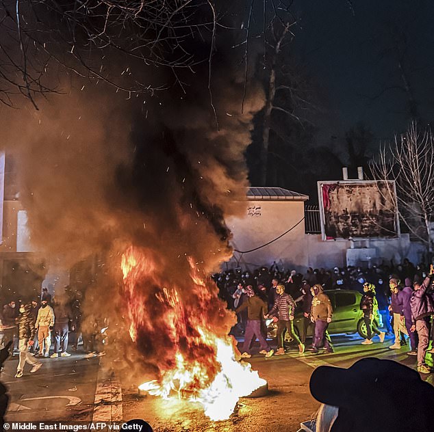Iranians gather while blocking a street during a protest in Tehran, Iran, on January 9, 2026