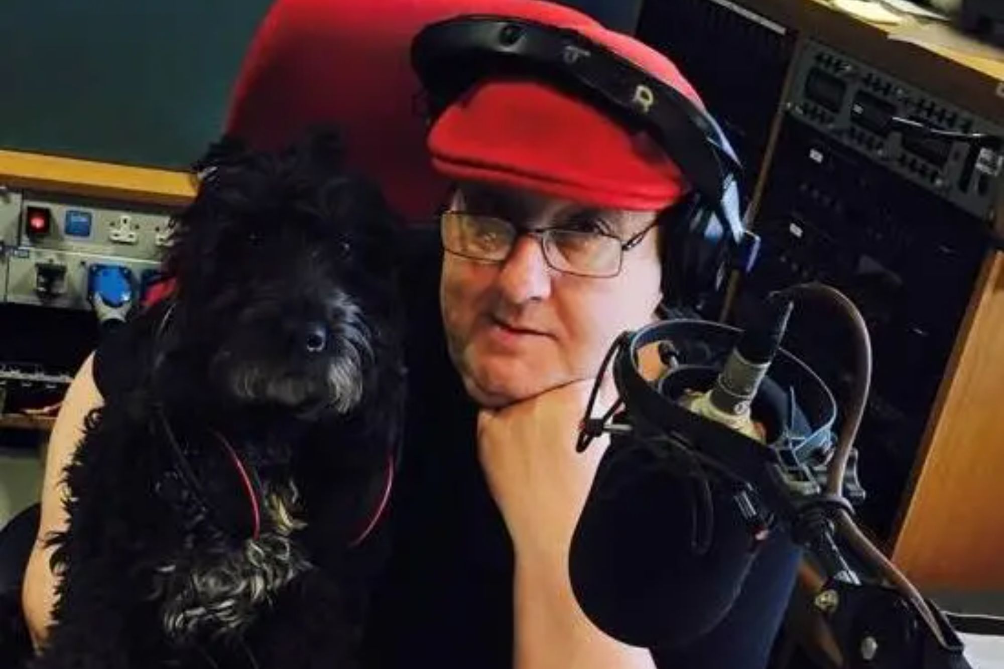 An image collage containing 1 images, Image 1 shows Man in a radio studio with a dog on his lap, both wearing headphones