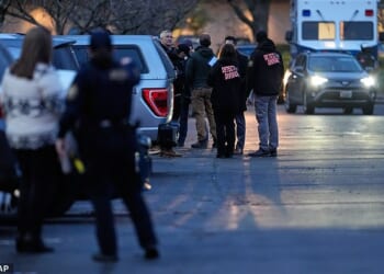 Law enforcement officials work the scene following reports that federal immigration officers shot and wounded people in Portland