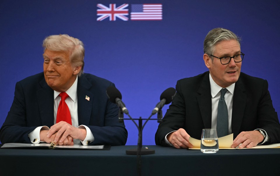 US President Donald Trump and British Prime Minister Keir Starmer seated at a table with microphones, with the US and UK flags in the background.
