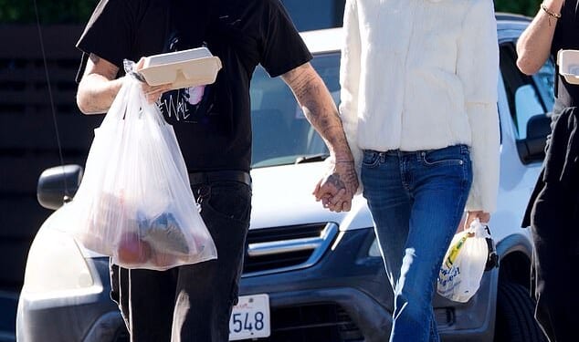 Brooklyn Beckham and Nicola Peltz looked smitten as they held hands at their local farmers' market in LA on Tuesday