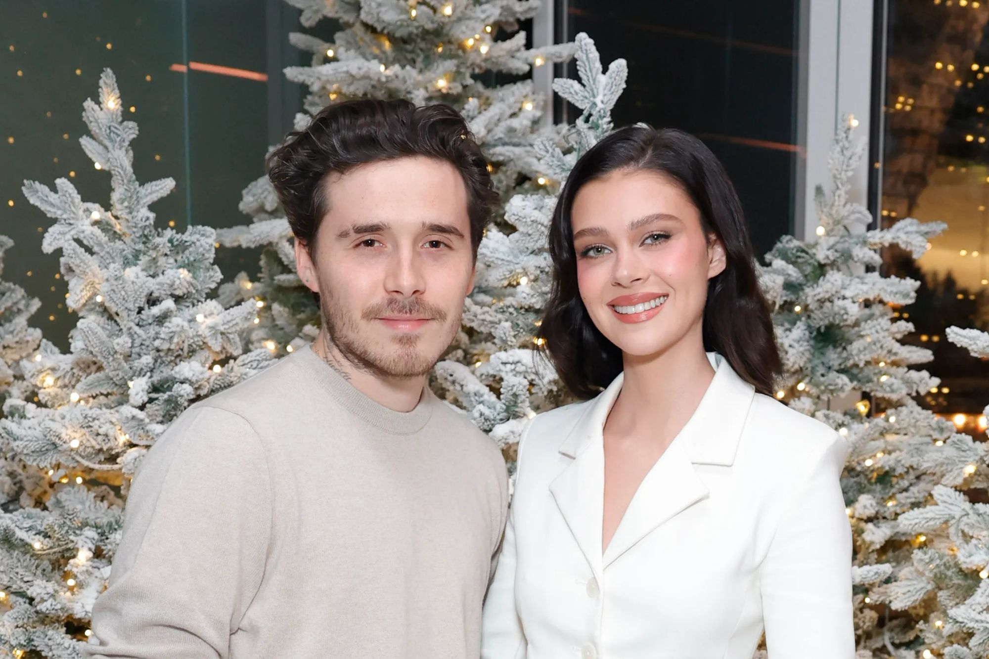An image collage containing 1 images, Image 1 shows Brooklyn Beckham and Nicola Peltz attend Revolve's Holiday Shop Grand Opening