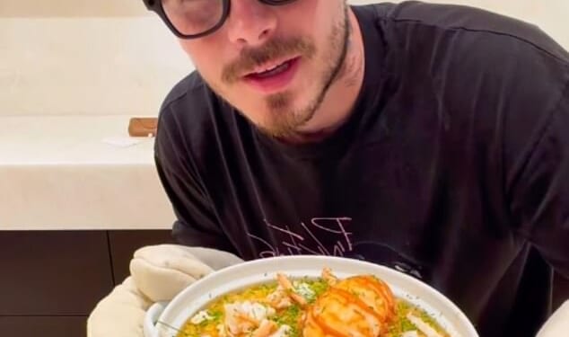 Brooklyn Beckham modelled a new pair of glasses as he uploaded a video cooking lobster mac and cheese after more details about his family feud emerged