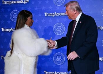 President Donald Trump and rapper Nicki Minaj embraced hands when she came on stage for quick remarks at a Trump Accounts event