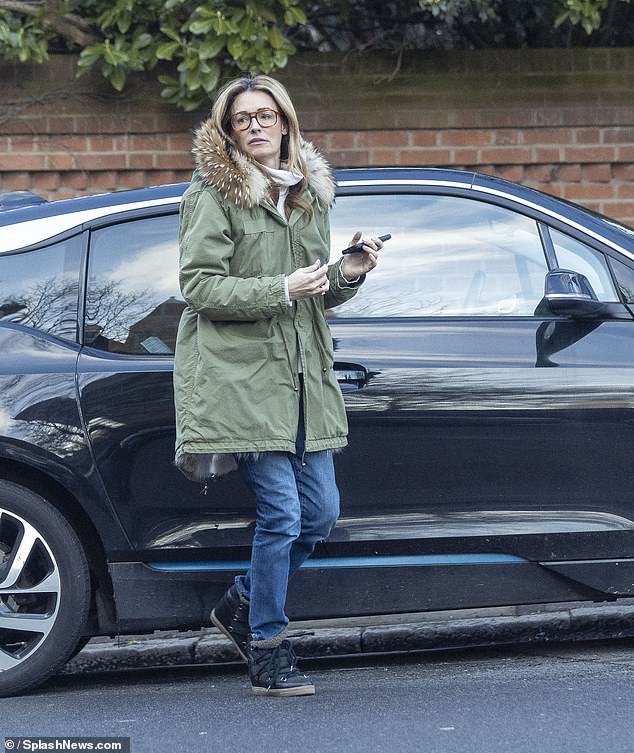 The TV presenter, 49, looked stylish in a pair of oversized aviator glasses and wrapped up warm in a khaki green parka with a fur-lined hood