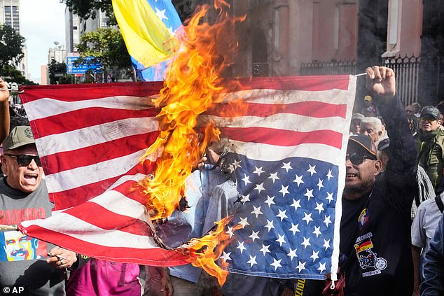 Maduro's supporters pictured burning the US flag in protest of his capture by American forces